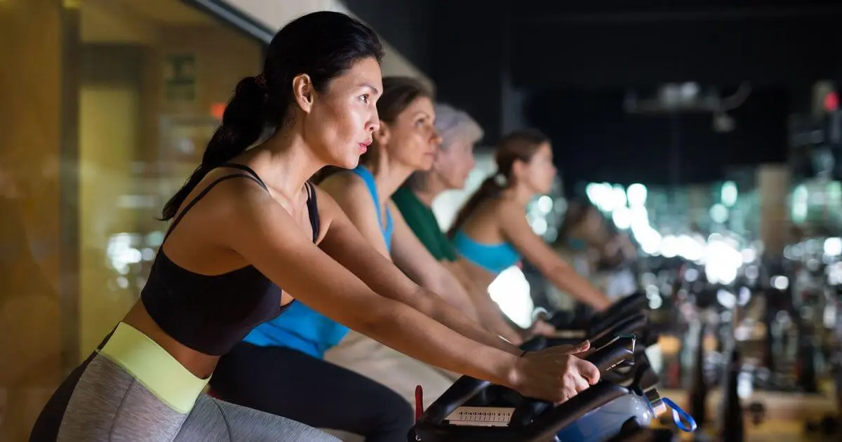 women exercising on indoor bicycles